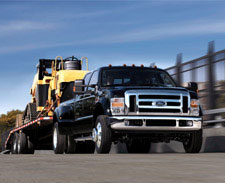 Truck pulling heavy equipment. Click this image to Shop for Car & Truck AMSOIL Lubrication